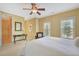 Sunlit bedroom boasting two windows, a ceiling fan, and neutral walls, creating a serene atmosphere at 105 New Castle Ln, Tyrone, GA 30290
