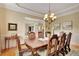 Charming dining room with hardwood floors and an ornate table and chairs at 105 New Castle Ln, Tyrone, GA 30290