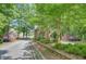 Neighborhood entrance with stone pillars and wrought iron gate at 105 New Castle Ln, Tyrone, GA 30290