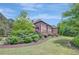 Brick home with lush foliage in manicured mulched beds surrounding the building at 105 New Castle Ln, Tyrone, GA 30290