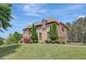 Elegant brick home with manicured lawn, sculpted shrubs, and verdant landscaping at 105 New Castle Ln, Tyrone, GA 30290