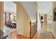 Hallway view of dining room with wood flooring, and staircase with wood railing at 105 New Castle Ln, Tyrone, GA 30290