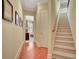 Hallway view of staircase and entry to bedroom with wood flooring and carpeted stairs at 105 New Castle Ln, Tyrone, GA 30290
