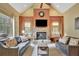 Bright living room with stone fireplace, high ceilings, and seating at 105 New Castle Ln, Tyrone, GA 30290