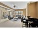 Living room with plush seating, ceiling fan, dining area and large windows at 105 New Castle Ln, Tyrone, GA 30290