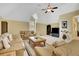 Cozy living room featuring vaulted ceilings, fan, plush seating, entertainment center, and lots of natural light at 105 New Castle Ln, Tyrone, GA 30290