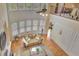 A view of the living room with high ceilings and large windows, allowing ample natural light at 105 New Castle Ln, Tyrone, GA 30290