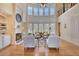 Bright living room with large windows, fireplace, hardwood floors and comfortable seating at 105 New Castle Ln, Tyrone, GA 30290