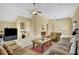 Comfortable living room with comfortable seating, ceiling fans, and carpeted floor at 105 New Castle Ln, Tyrone, GA 30290