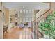 Open living room with a fireplace, high ceilings, large windows, and hardwood floors at 105 New Castle Ln, Tyrone, GA 30290