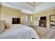 A main bedroom with a fireplace, sitting area, tray ceiling, and ensuite bathroom at 105 New Castle Ln, Tyrone, GA 30290