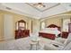 Spacious main bedroom features a tray ceiling, large bed, and sitting area at 105 New Castle Ln, Tyrone, GA 30290