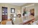 Well-lit office space with desk, sitting area, hardwood floors and attractive built-in shelving at 105 New Castle Ln, Tyrone, GA 30290