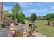 Inviting outdoor patio with a stone fireplace and manicured lawn leading to the house at 105 New Castle Ln, Tyrone, GA 30290