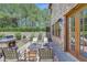 Charming outdoor patio featuring a stone fireplace and comfortable seating area at 105 New Castle Ln, Tyrone, GA 30290