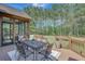 Covered deck with outdoor seating, providing a comfortable space for dining and relaxing with nature views at 105 New Castle Ln, Tyrone, GA 30290