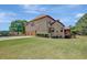 View of the rear exterior showing the brick facade and 3-car garage at 105 New Castle Ln, Tyrone, GA 30290