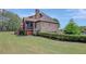 Rear exterior view of the home, showcasing the brick facade and manicured lawn at 105 New Castle Ln, Tyrone, GA 30290
