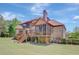 View of the rear exterior showing a deck, screened porch, and brick facade at 105 New Castle Ln, Tyrone, GA 30290