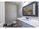 Clean bathroom featuring a vanity with sink, toilet, and shower with patterned curtain at 1215 Smoke Hill Ln, Hoschton, GA 30548