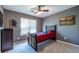 Bright bedroom with baseball themed decor and a ceiling fan at 1215 Smoke Hill Ln, Hoschton, GA 30548