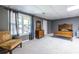 Spacious bedroom with neutral carpet and paint and a sunny window with views of the outdoor space at 1215 Smoke Hill Ln, Hoschton, GA 30548
