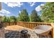 Wooden deck with seating area and gas fire pit, perfect for outdoor entertaining on a summer night at 1215 Smoke Hill Ln, Hoschton, GA 30548