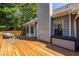 Wooden deck with exterior storage and seating with access to the house and outdoor space at 1215 Smoke Hill Ln, Hoschton, GA 30548