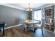 Charming dining area featuring a round table, elegant chairs, and natural light from the window at 1215 Smoke Hill Ln, Hoschton, GA 30548