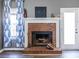 Classic brick fireplace in a cozy living area, featuring a white mantel, hearth, and adjacent doorway at 1215 Smoke Hill Ln, Hoschton, GA 30548