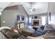 Bright living room with a vaulted ceiling, brick fireplace, a comfortable sofa, and stylish furnishings at 1215 Smoke Hill Ln, Hoschton, GA 30548