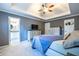 Comfortable main bedroom featuring a TV, dresser, and en-suite bathroom access at 1215 Smoke Hill Ln, Hoschton, GA 30548