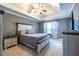 Spacious main bedroom with tray ceiling, neutral decor, and ample natural light at 1215 Smoke Hill Ln, Hoschton, GA 30548