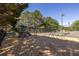 Community playground with climbing structures and a dome surrounded by trees and a fence at 1215 Smoke Hill Ln, Hoschton, GA 30548