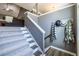 Inviting stairway with wood and carpet treads leading to the home's upper level with neutral paint at 1215 Smoke Hill Ln, Hoschton, GA 30548