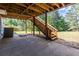 Under deck space with stairs leading to backyard and a shaded patio at 1215 Smoke Hill Ln, Hoschton, GA 30548