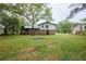 Large, grassy backyard featuring the back of house with stairs at 382 Plantation Blvd, Lawrenceville, GA 30046