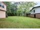 Expansive backyard with lush green lawn, mature trees, and space for recreation and relaxation at 382 Plantation Blvd, Lawrenceville, GA 30046