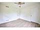 Bedroom featuring clean walls, stylish, light wood-look flooring, and a modern ceiling fan at 382 Plantation Blvd, Lawrenceville, GA 30046
