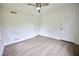 This bedroom offers clean walls, stylish, light wood-look flooring, and modern ceiling fan at 382 Plantation Blvd, Lawrenceville, GA 30046