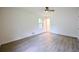 Bedroom featuring clean walls, stylish, light wood-look flooring, window, and door to hall at 382 Plantation Blvd, Lawrenceville, GA 30046