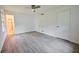 Bedroom featuring clean walls, stylish, light wood-look flooring, window, and door to bathroom at 382 Plantation Blvd, Lawrenceville, GA 30046