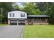 Charming split-level home features a brick facade, a covered porch, and a two-car garage at 382 Plantation Blvd, Lawrenceville, GA 30046