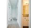 Hallway featuring wood-look floors and a view into a bathroom with granite countertops at 382 Plantation Blvd, Lawrenceville, GA 30046