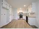 Well-lit kitchen boasts white cabinetry, stainless steel appliances, and updated countertops at 382 Plantation Blvd, Lawrenceville, GA 30046