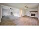 Spacious living room with a decorative fireplace, light-colored walls, and wood-look flooring at 382 Plantation Blvd, Lawrenceville, GA 30046