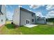 New backyard with a small patio and green lawn with gray siding on house at 4495 Buttonwood Ln, Lilburn, GA 30047