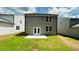 Newly built backyard featuring a concrete patio and lush green lawn at 4495 Buttonwood Ln, Lilburn, GA 30047