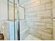 Modern bathroom featuring a tiled shower with glass doors and a built in seat at 4495 Buttonwood Ln, Lilburn, GA 30047