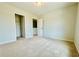 Bedroom with neutral carpet, walk-in closet, and a door to another room at 4495 Buttonwood Ln, Lilburn, GA 30047